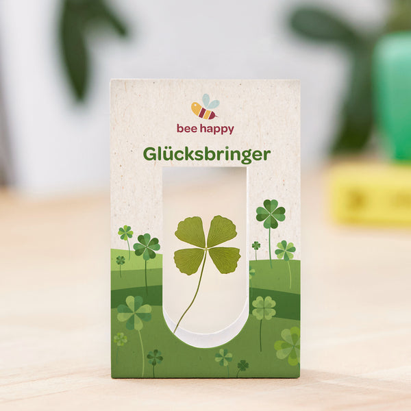 Clover with 4 leaves between 2 glasses in one package